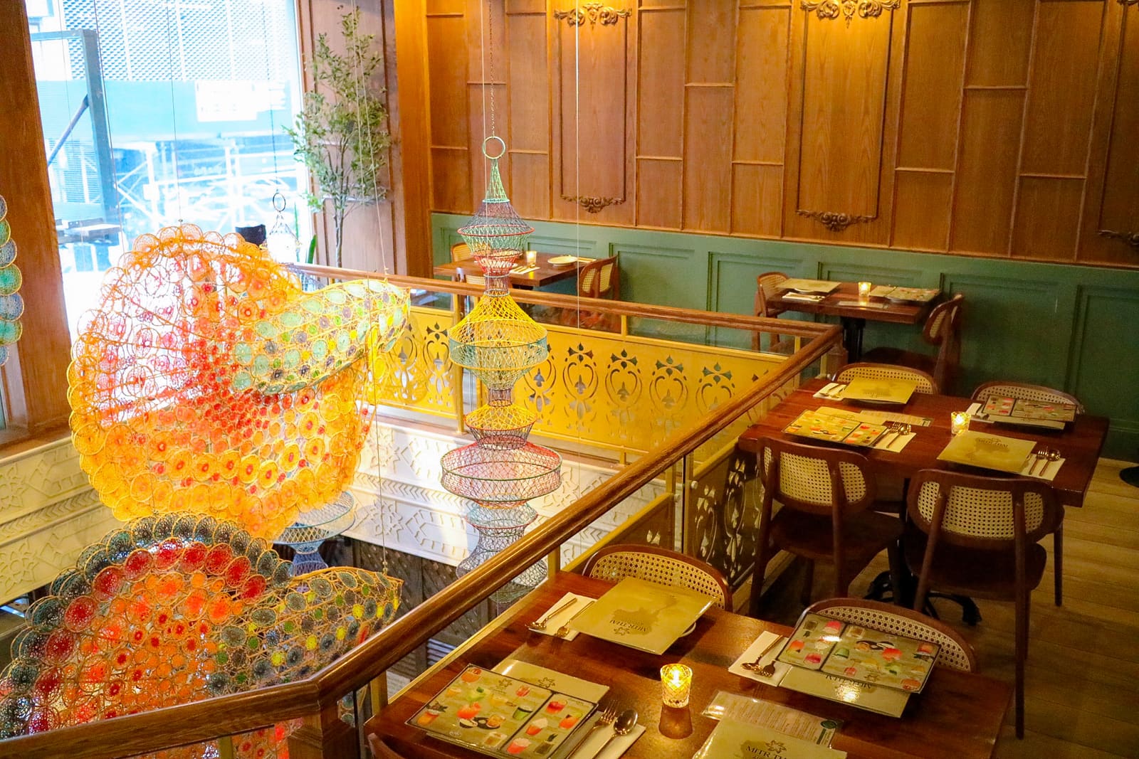 The mezzanine dining room at Mitr Thai, with woven fish sculptures